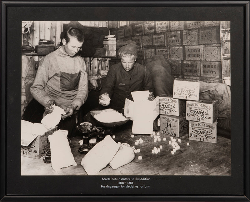 Classic Herbert Ponting photograph from Captain Scott's Terra Nova expedition (1910-1913), showing packing sugar for sledging rations.