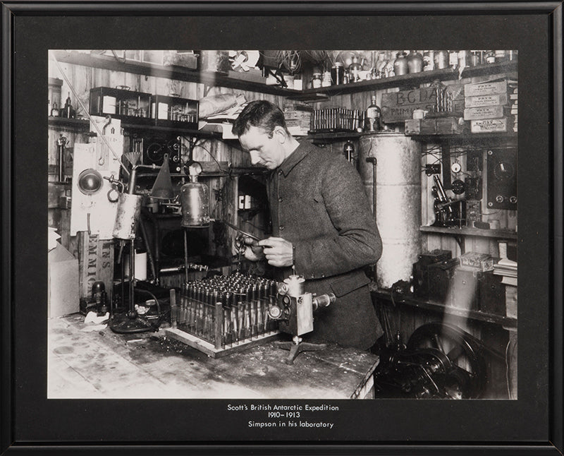 Classic Herbert Ponting photograph from Captain Scott's Terra Nova expedition (1910-1913), showing George Simpson in his laboratory in the Hut.