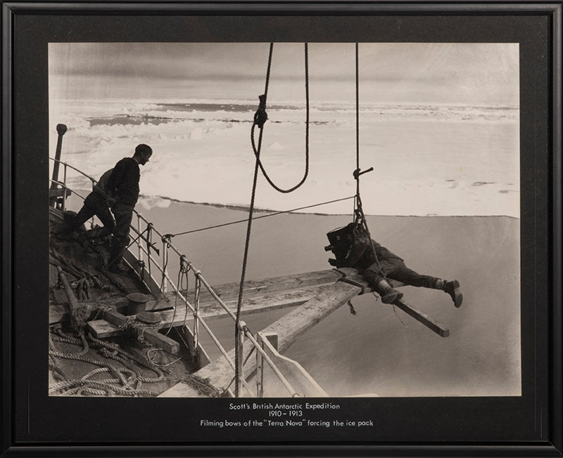 Classic photograph by Herbert Ponting from Captain Scott's expedition (1910-1913), showing Ponting filming the Terra Nova forcing the ice pack.