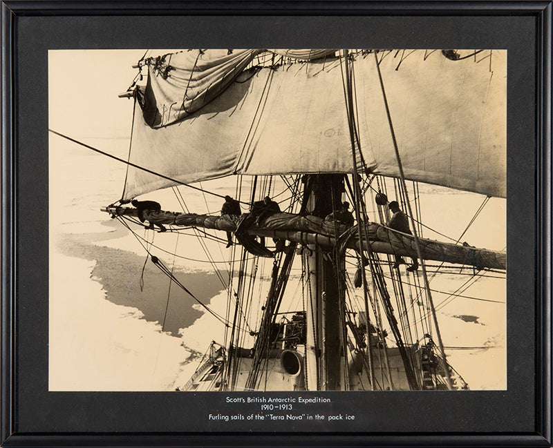 Classic Herbert Ponting photograph from Captain Scott's Terra Nova expedition (1910-1913), showing the ship's sails being furled in the pack ice.