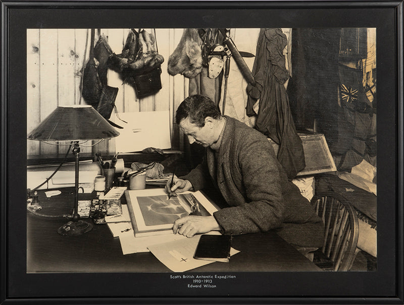 Classic Herbert Ponting photograph from Captain Scott's Terra Nova expedition (1910-1913), showing Edward Wilson working on a watercolour drawing