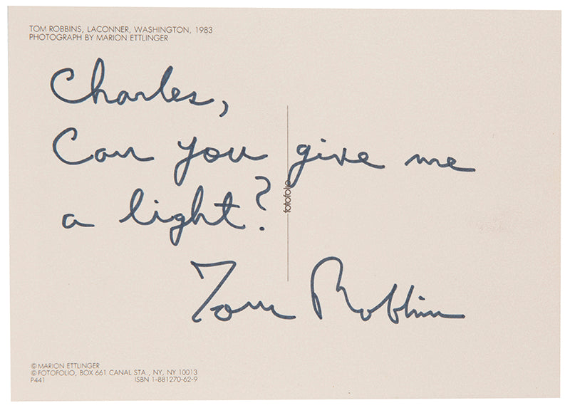 First UK edition of Another Roadside Attraction by Tom Robbins, with a signed photograph loosely inserted.