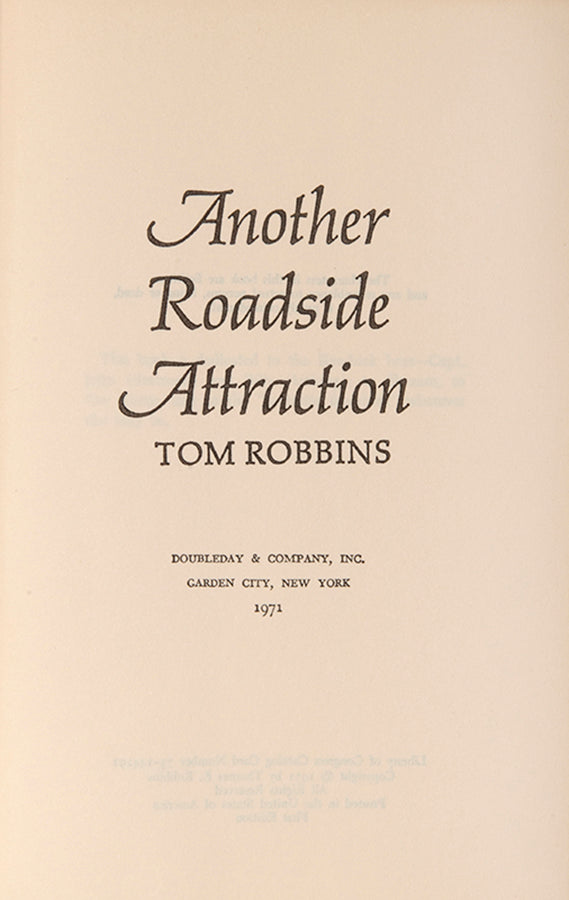 First edition of Another Roadside Attraction by Tom Robbins, signed by the author.