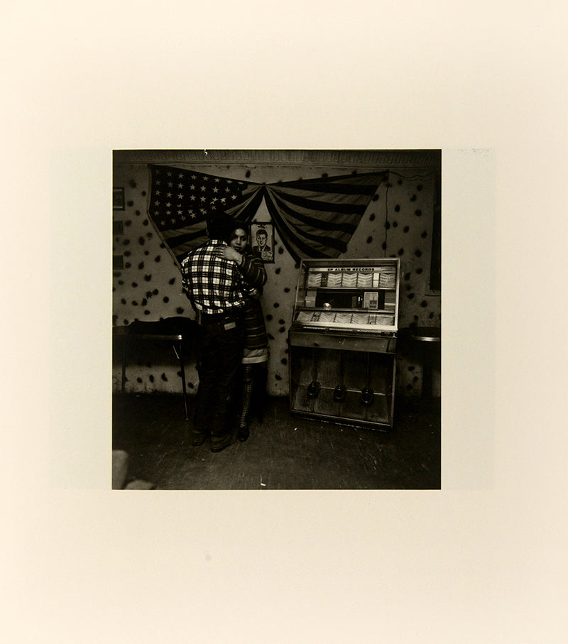 Bruce Davidson regularly visited East Harlem with a view camera and tripod with which he photographed the residents of a city block on East 100th Street between First and Second Avenues in New York. Davidson chose this block because, at the time, it had a reputation as being one of the worst in the city.