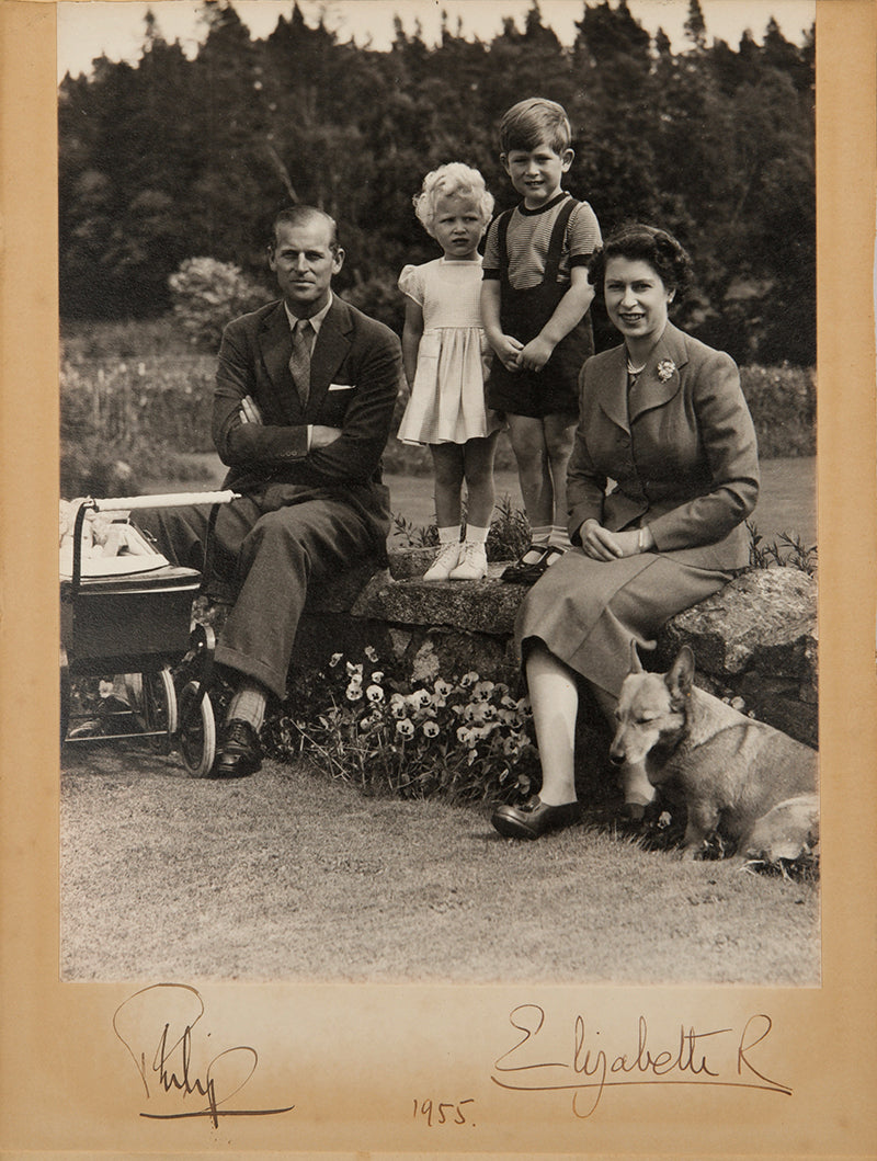 A signed photograph of Queen Elizabeth II, Prince Philip, Prince Charles and Princess Anne at Balmoral Castle, Scotland, 1955, taken by Marcus Adams