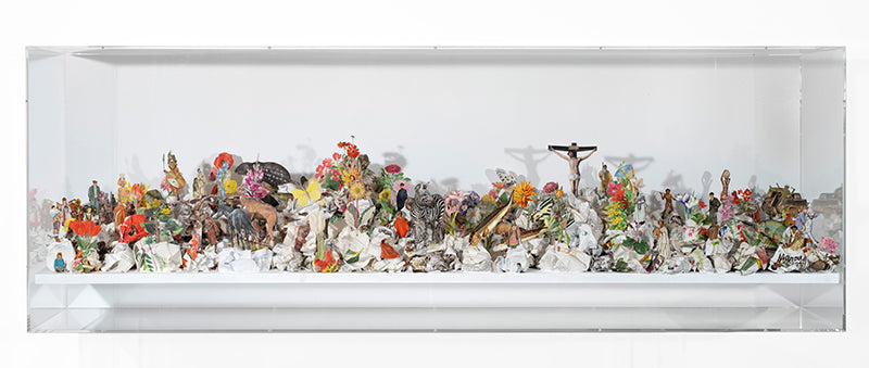 Cut and crumpled book page construction in an acrylic case by Jake Milroy, titled A Trashcan World.