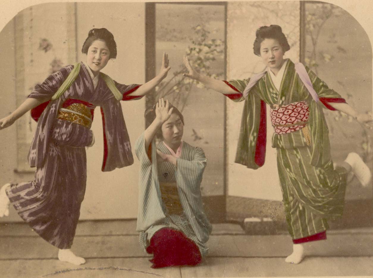 An albumen print showing a group of three maiko (apprentice geisha) dancing, circa 1880s