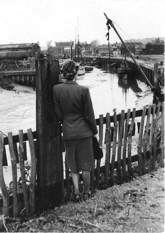 Woman Beside Industrial Estuary.