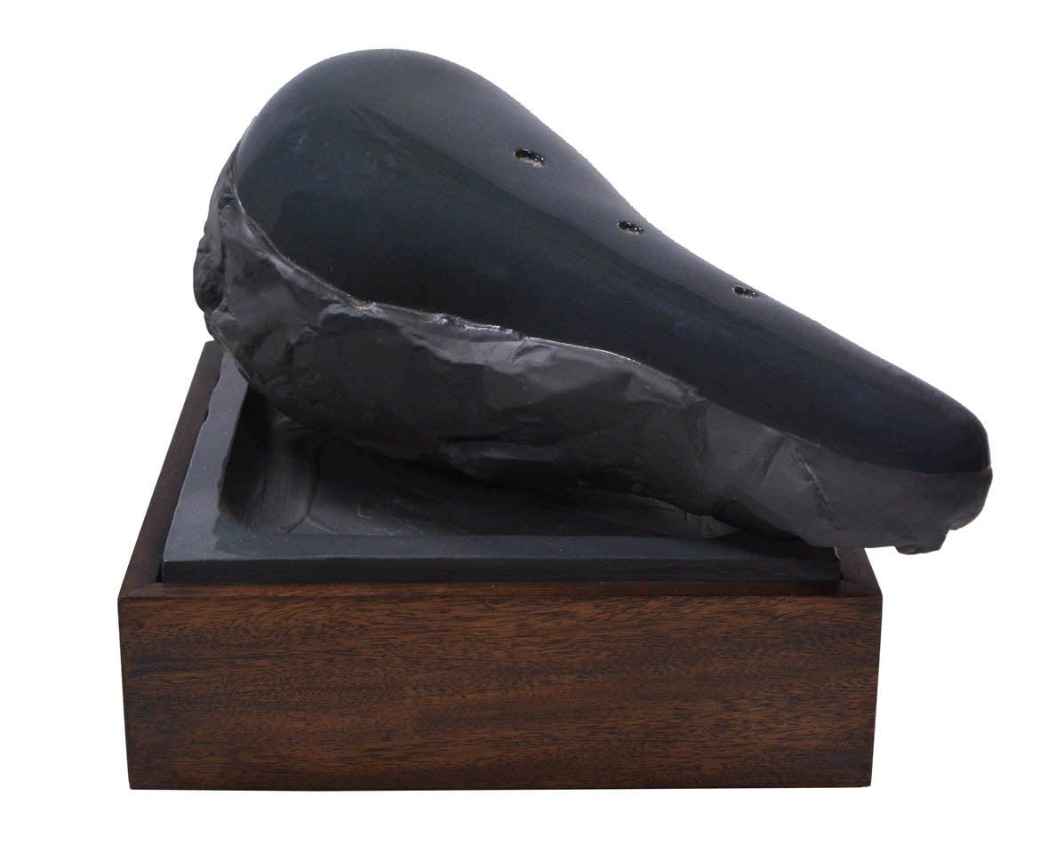 Claes Oldenburg, Sculpture in the Form of a Bicycle Saddle, 1976, cast ceramic, mahogany, sand, signed, from the edition of 36