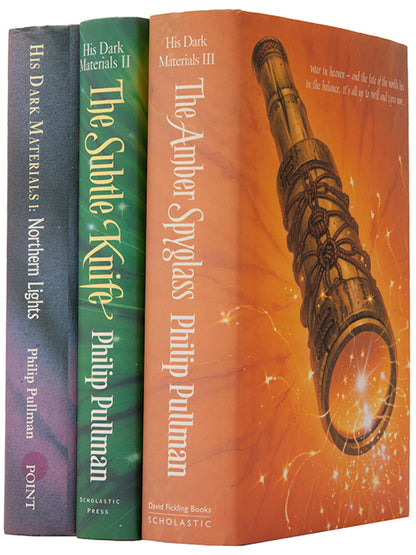 First UK editions of Philip Pullman's acclaimed fantasy trilogy His Dark Materials, signed by the author on the title of The Northern Lights.