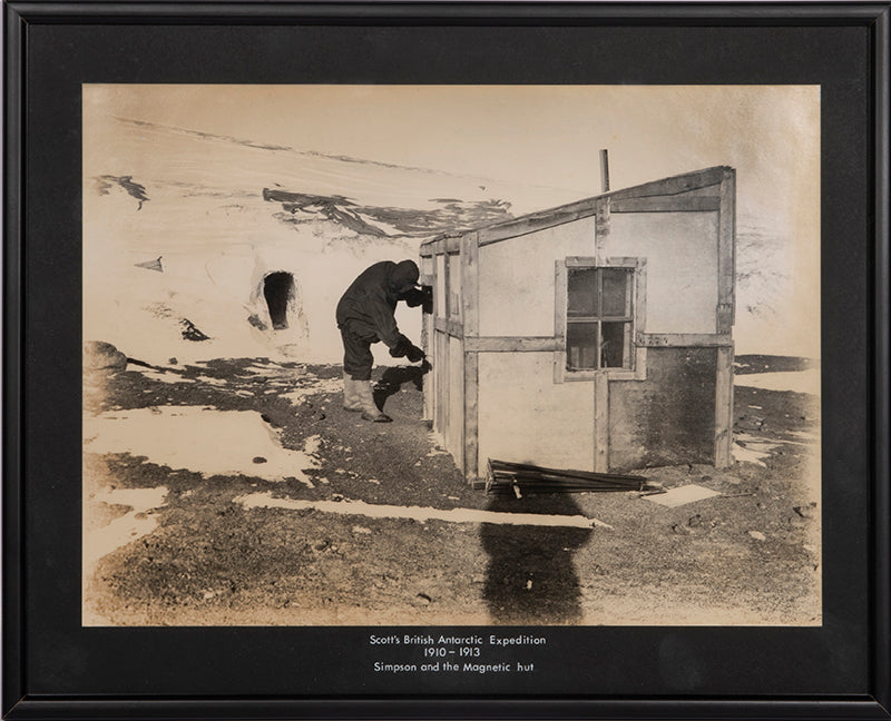 Classic Herbert Ponting photograph from Captain Scott's Terra Nova expedition (1910-1913), showing meteorologist George Simpson and the magnetic hut.