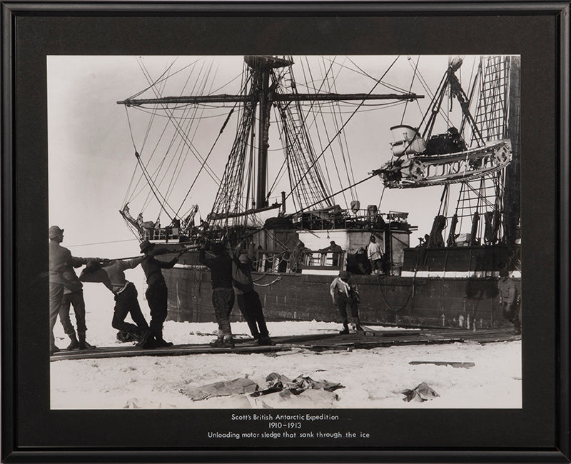 Classic Herbert Ponting photograph from Captain Scott's Terra Nova expedition (1910-1913), showing the unloading of the first motor sledge.