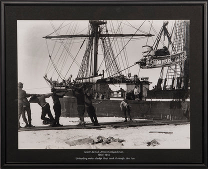 Classic Herbert Ponting photograph from Captain Scott's Terra Nova expedition (1910-1913), showing the unloading of the first motor sledge.