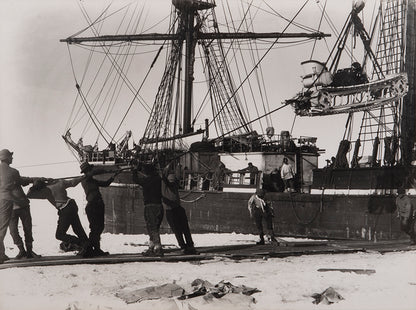 Classic Herbert Ponting photograph from Captain Scott's Terra Nova expedition (1910-1913), showing the unloading of the first motor sledge.