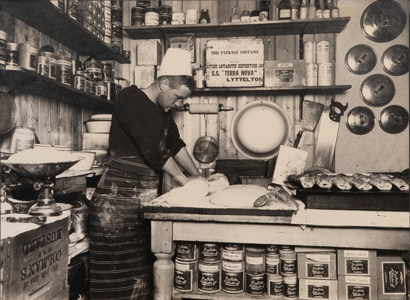 Classic Herbert Ponting photograph from Captain Scott's Terra Nova expedition (1910-1913), whosing Thomas Clissold making bread.