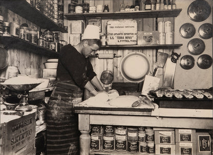 Classic Herbert Ponting photograph from Captain Scott's Terra Nova expedition (1910-1913), whosing Thomas Clissold making bread.