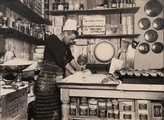 Classic Herbert Ponting photograph from Captain Scott's Terra Nova expedition (1910-1913), whosing Thomas Clissold making bread.