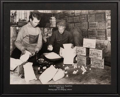 Classic Herbert Ponting photograph from Captain Scott's Terra Nova expedition (1910-1913), showing packing sugar for sledging rations.