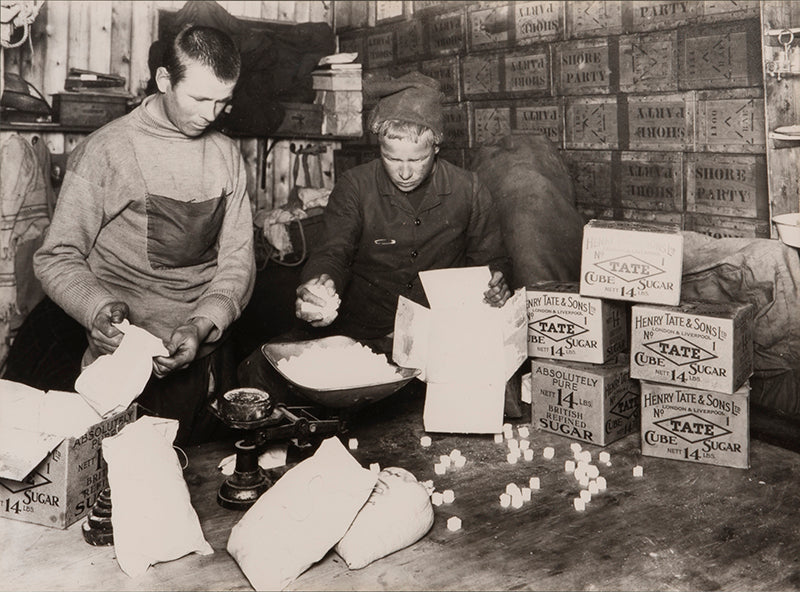 Classic Herbert Ponting photograph from Captain Scott's Terra Nova expedition (1910-1913), showing packing sugar for sledging rations.