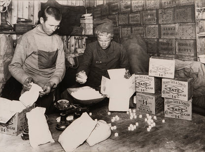 Classic Herbert Ponting photograph from Captain Scott's Terra Nova expedition (1910-1913), showing packing sugar for sledging rations.