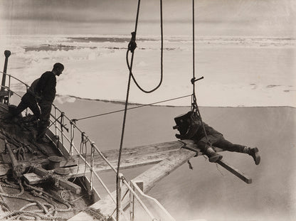 Classic photograph by Herbert Ponting from Captain Scott's expedition (1910-1913), showing Ponting filming the Terra Nova forcing the ice pack.