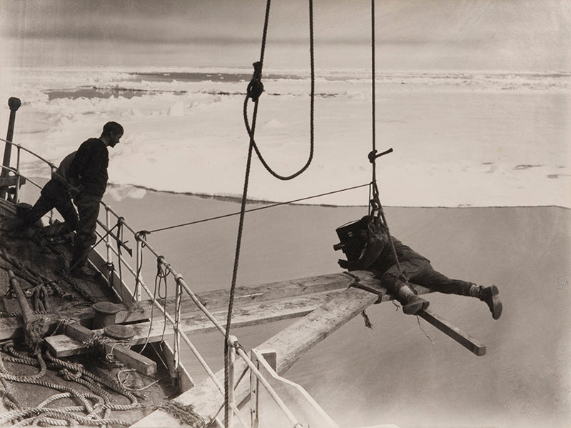 Classic photograph by Herbert Ponting from Captain Scott's expedition (1910-1913), showing Ponting filming the Terra Nova forcing the ice pack.