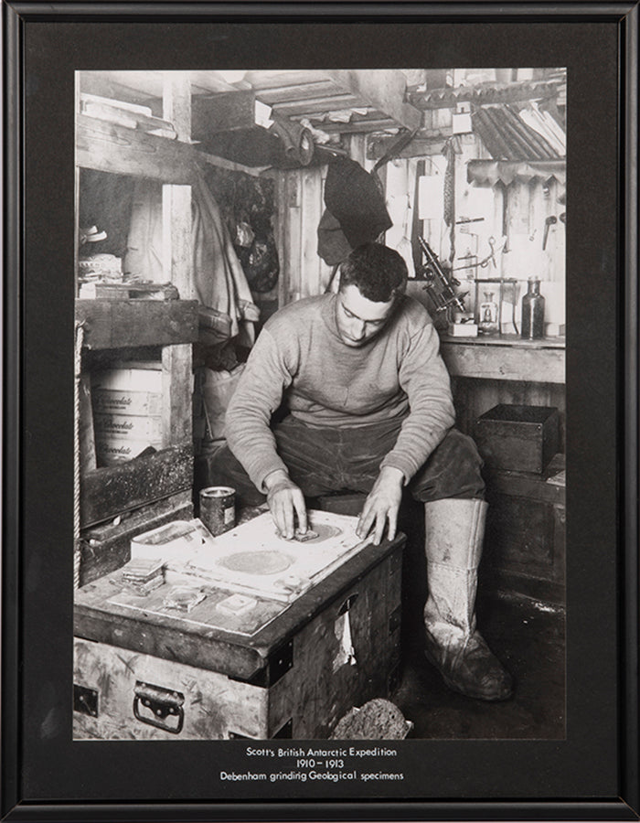 Classic Herbert Ponting photograph from Captain Scott's Terra Nova expedition (1910-1913), showing Frank Debenham grinding geological specimens.