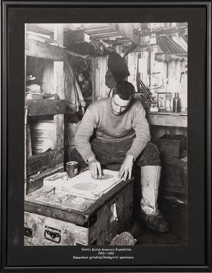Classic Herbert Ponting photograph from Captain Scott's Terra Nova expedition (1910-1913), showing Frank Debenham grinding geological specimens.