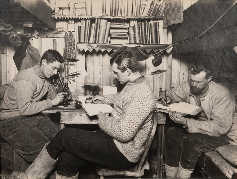 Classic Herbert Ponting photograph from Captain Scott's Terra Nova expedition (1910-1913), showing Taylor, Debenham and Gran in the Hut at Cape Evans