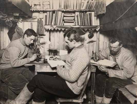 Classic Herbert Ponting photograph from Captain Scott's Terra Nova expedition (1910-1913), showing Taylor, Debenham and Gran in the Hut at Cape Evans