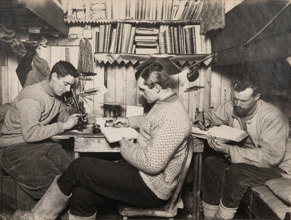 Classic Herbert Ponting photograph from Captain Scott's Terra Nova expedition (1910-1913), showing Taylor, Debenham and Gran in the Hut at Cape Evans