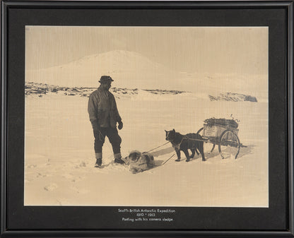 Classic Herbert Ponting photograph from Captain Scott's Terra Nova expedition (1910-1913), showing Ponting with his dog-pulled camera sledge