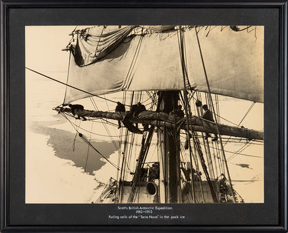 Classic Herbert Ponting photograph from Captain Scott's Terra Nova expedition (1910-1913), showing the ship's sails being furled in the pack ice.