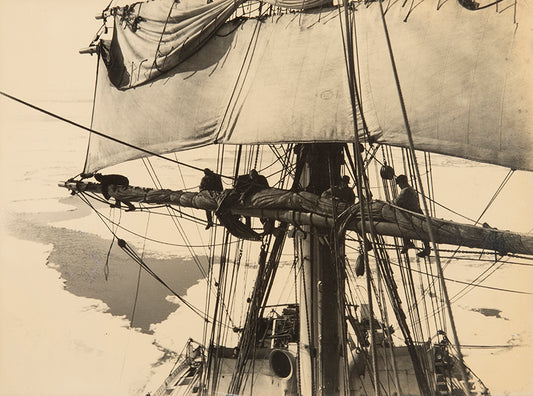 Classic Herbert Ponting photograph from Captain Scott's Terra Nova expedition (1910-1913), showing the ship's sails being furled in the pack ice.
