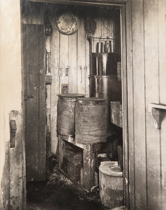 Classic Herbert Ponting photograph from Captain Scott's Terra Nova expedition (1910-1913), showing the plant where acetylene gas was produced.