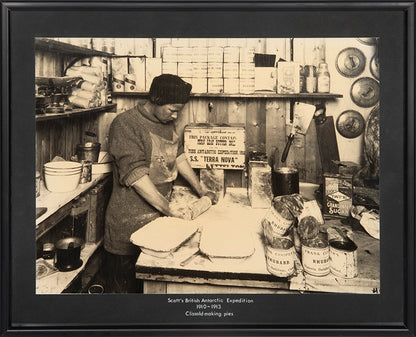Classic Herbert Ponting photograph from Captain Scott's Terra Nova expedition (1910-1913), showing Thomas Clissold making rhubarb pies.