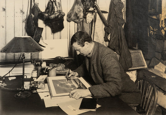 Classic Herbert Ponting photograph from Captain Scott's Terra Nova expedition (1910-1913), showing Edward Wilson working on a watercolour drawing
