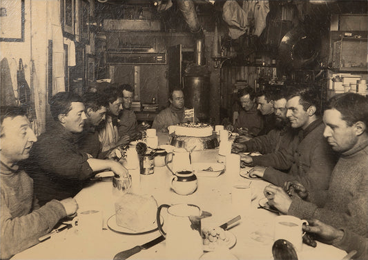 Classic photograph by Herbert Ponting from Captain Scott's Terra Nova expedition (1910-1913) showing Captain Scott's last birthday dinner.