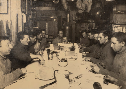 Classic photograph by Herbert Ponting from Captain Scott's Terra Nova expedition (1910-1913) showing Captain Scott's last birthday dinner.