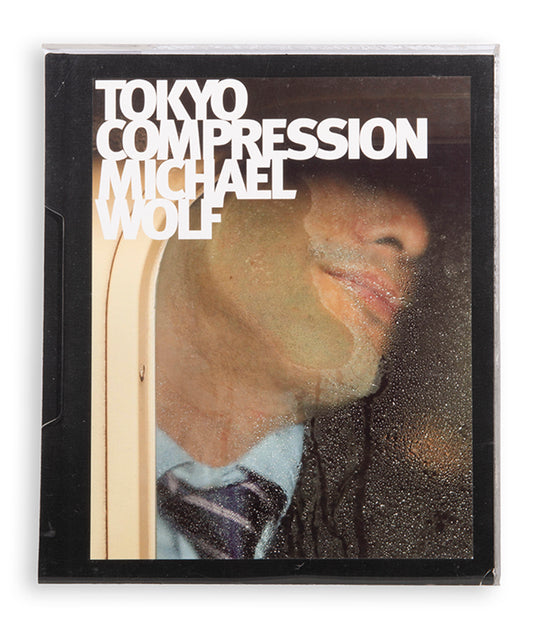 Tokyo Compression comprises Michael Wolf's candid photographs of Japanese commuters in Tokyo's crowded subway cars.