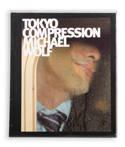 Tokyo Compression comprises Michael Wolf's candid photographs of Japanese commuters in Tokyo's crowded subway cars.