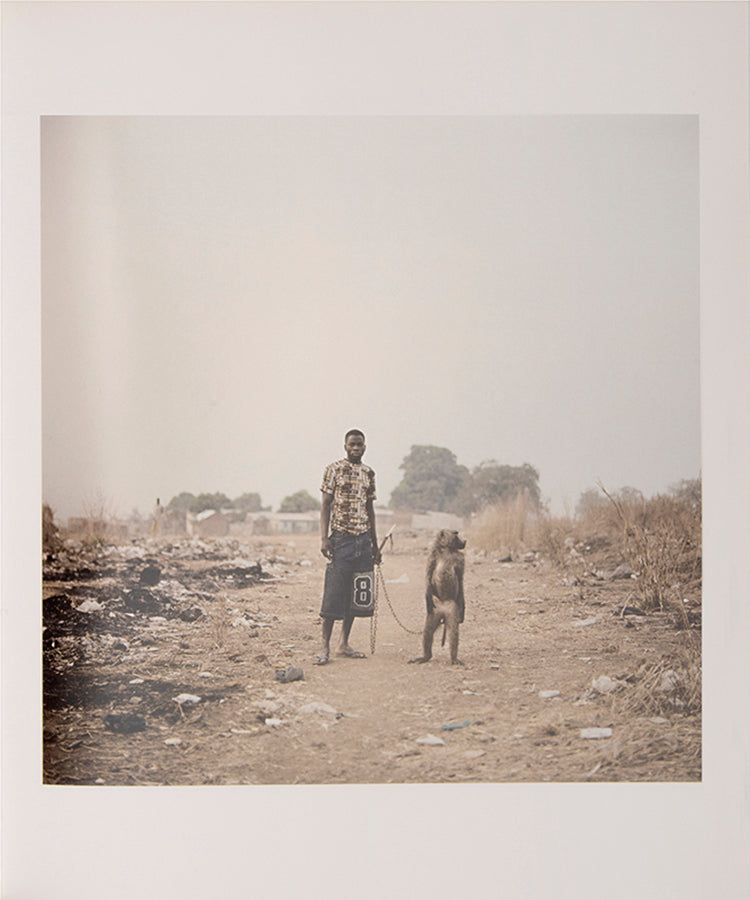The men in Pieter Hugo's The Hyena and Other Men earn a living by performing before crowds in the peripheries of Nigerian cities, accompanied by hyenas, rock pythons and baboons, and selling traditional medicines.