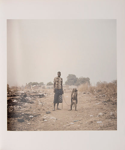 The men in Pieter Hugo's The Hyena and Other Men earn a living by performing before crowds in the peripheries of Nigerian cities, accompanied by hyenas, rock pythons and baboons, and selling traditional medicines.