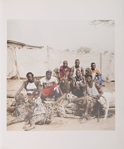 The men in Pieter Hugo's The Hyena and Other Men earn a living by performing before crowds in the peripheries of Nigerian cities, accompanied by hyenas, rock pythons and baboons, and selling traditional medicines.