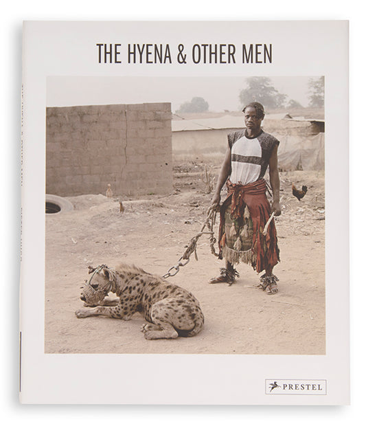 The men in Pieter Hugo's The Hyena and Other Men earn a living by performing before crowds in the peripheries of Nigerian cities, accompanied by hyenas, rock pythons and baboons, and selling traditional medicines.