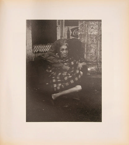 Bruce Davidson regularly visited East Harlem with a view camera and tripod with which he photographed the residents of a city block on East 100th Street between First and Second Avenues in New York. Davidson chose this block because, at the time, it had a reputation as being one of the worst in the city.