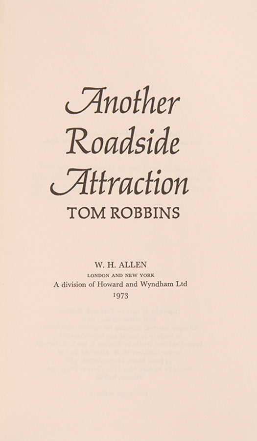 First UK edition of Another Roadside Attraction by Tom Robbins, with a signed photograph loosely inserted.