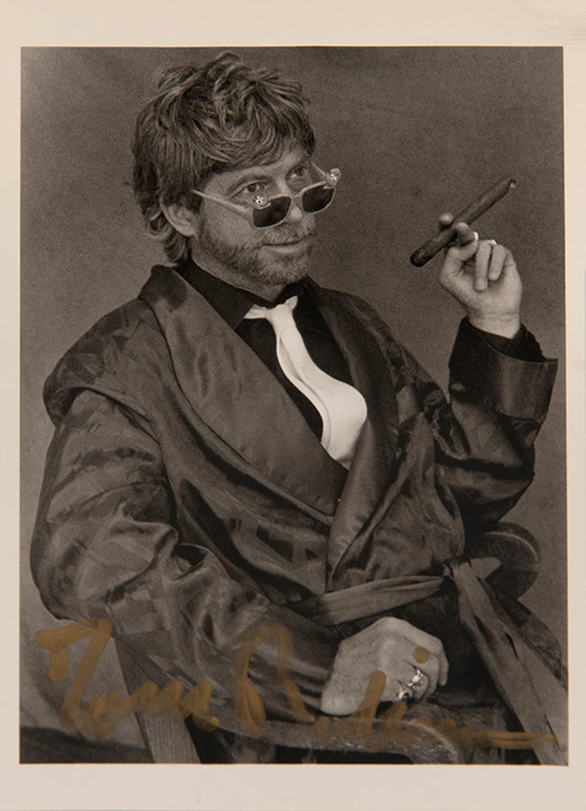 First UK edition of Another Roadside Attraction by Tom Robbins, with a signed photograph loosely inserted.