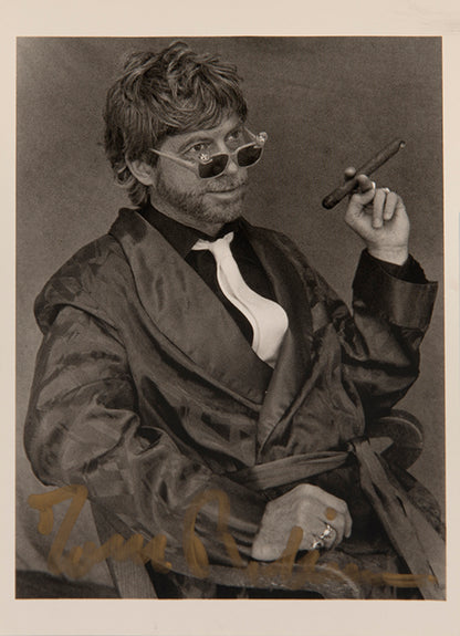 First UK edition of Another Roadside Attraction by Tom Robbins, with a signed photograph loosely inserted.