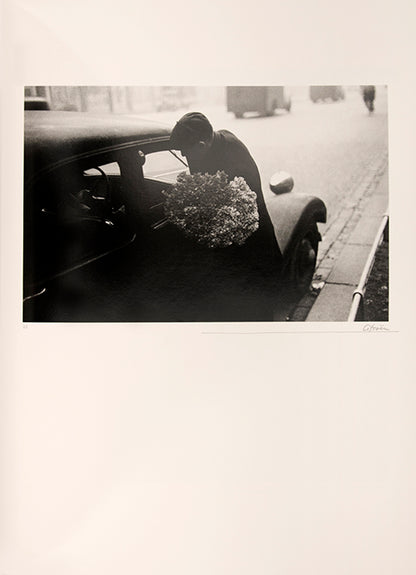 Robert Frank's Flower Is consists of three bodies of work. It begins with photographs taken in Paris of flowers, flower sellers, and chance encounters on the street, continues in a car factory in Detroit, and ends with polaroids made in Mabou Mines, Nova Scotia.